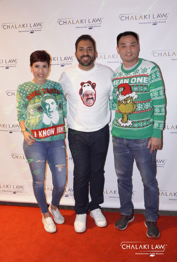 Sean Chalaki with two people wearing green sweaters